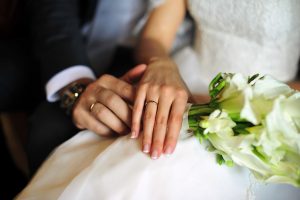 bride and groom hands with wedding rings | taxes and marriage