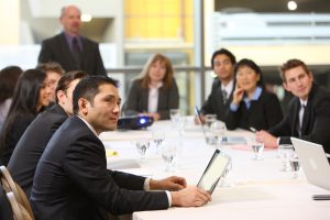 people reviewing merger and acquisition in board room