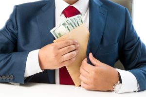 man putting envelope of cash into his jacket
