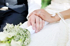 close up of hands of man and woman just married | marriage penalty