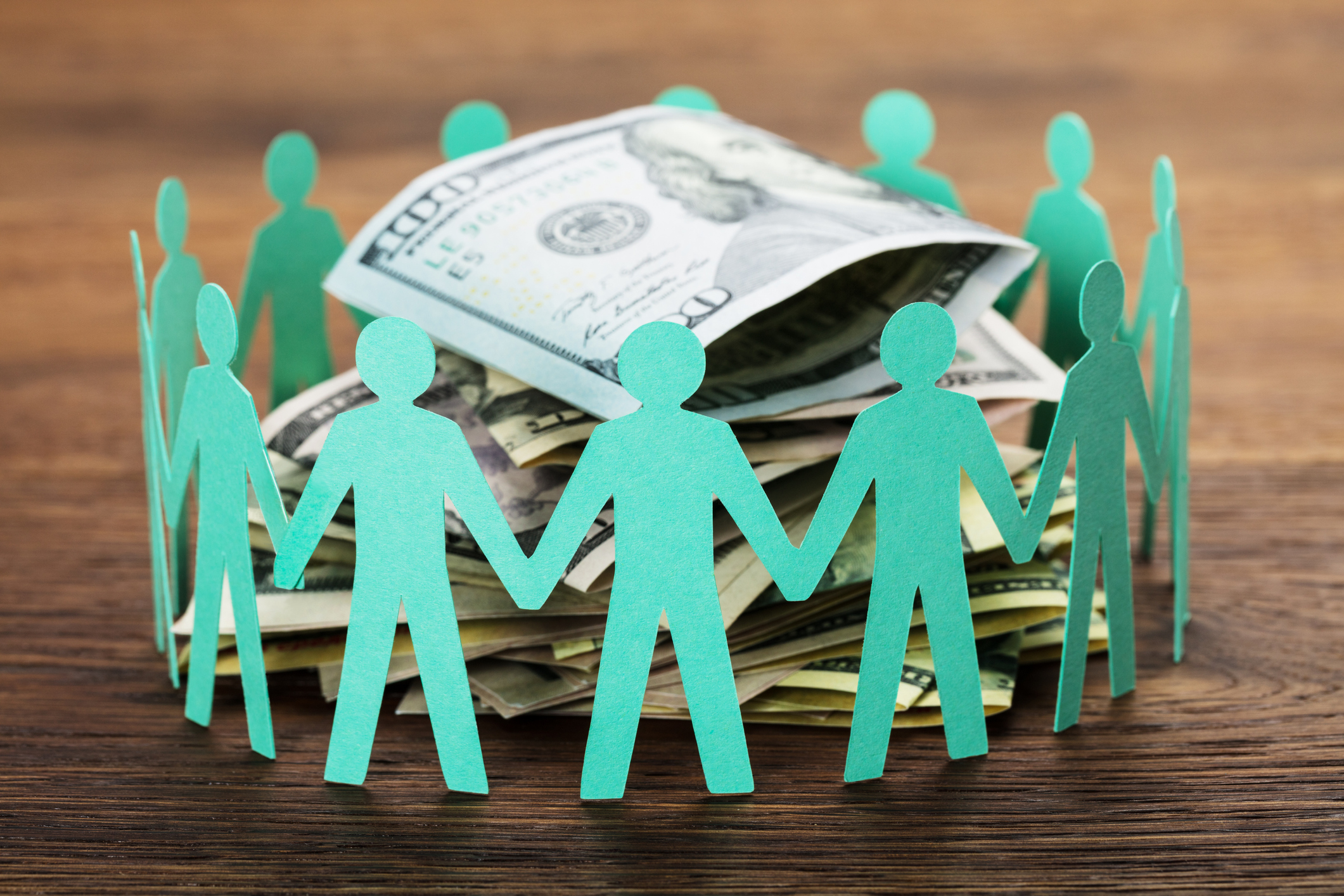 nonprofit crowdfunding with a stack of cash surrounded by people