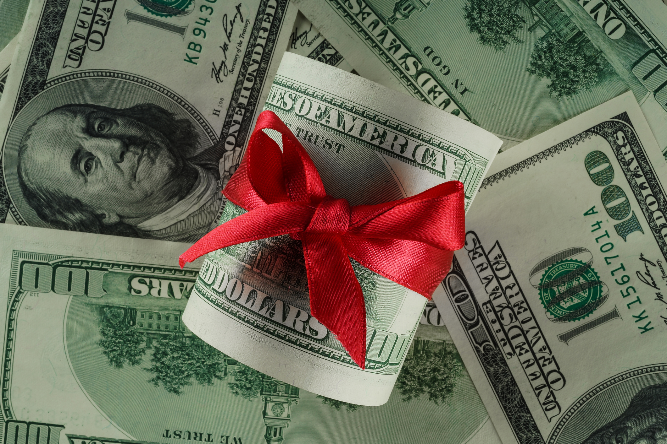 Gift Tax and Estate Tax as 100 dollar bills tied with ribbon