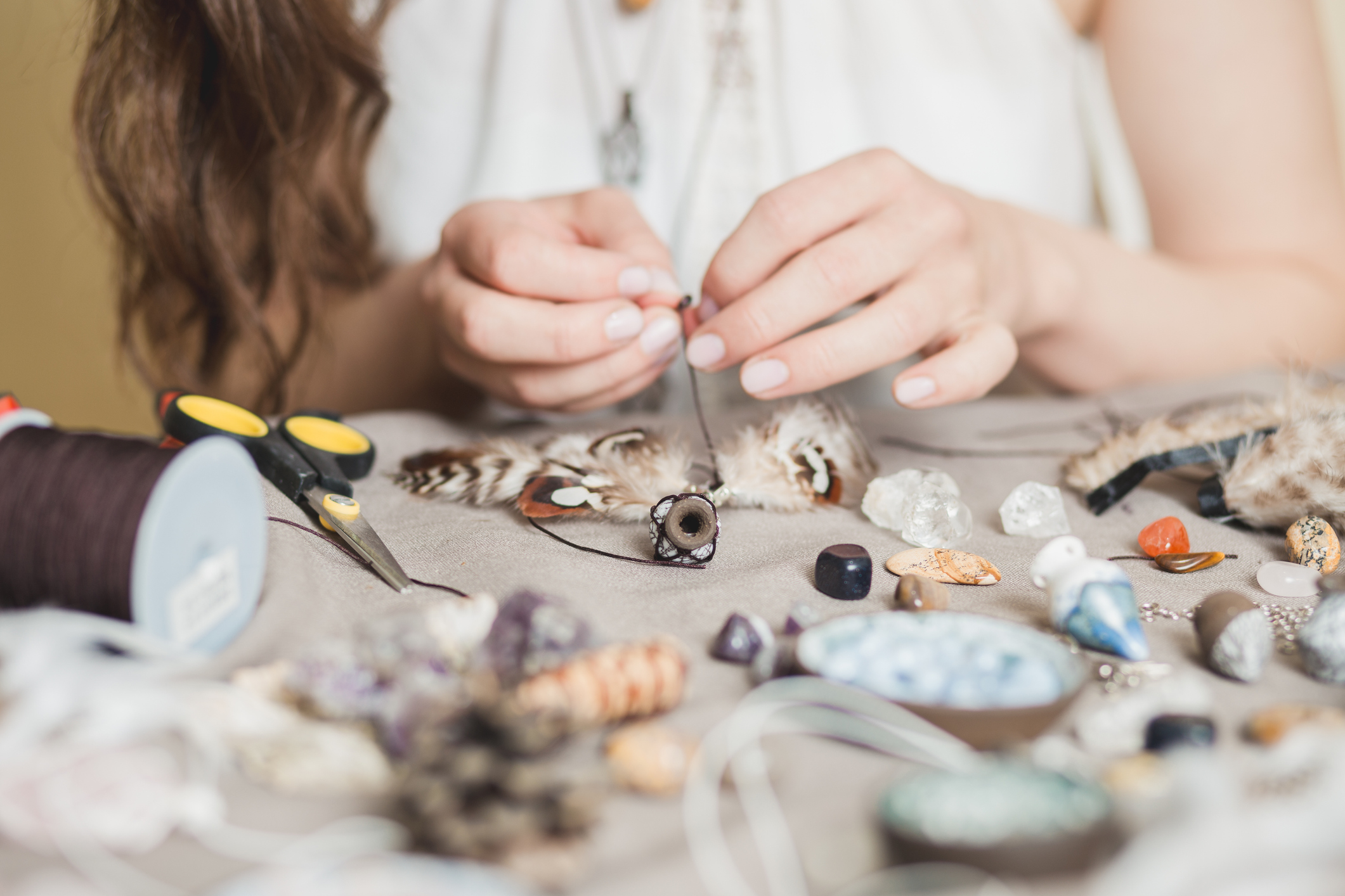 woman making beaded craft and reviewing tax issues related to hobbies