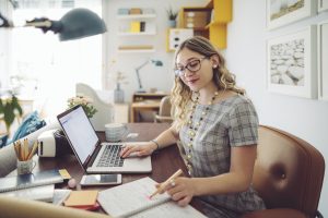 woman working on accounting processes at home office